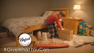 Image from the 2020 Hafod Hardware holiday advert, featuring 3 year old Arthur wrapping household items for Christmas.